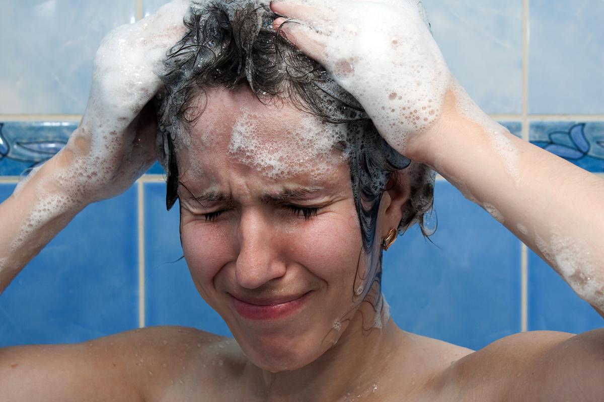 Моет глаза. Мытье головы. Мытье волос в ванной. Намыленная голова. Девушка моет голову.