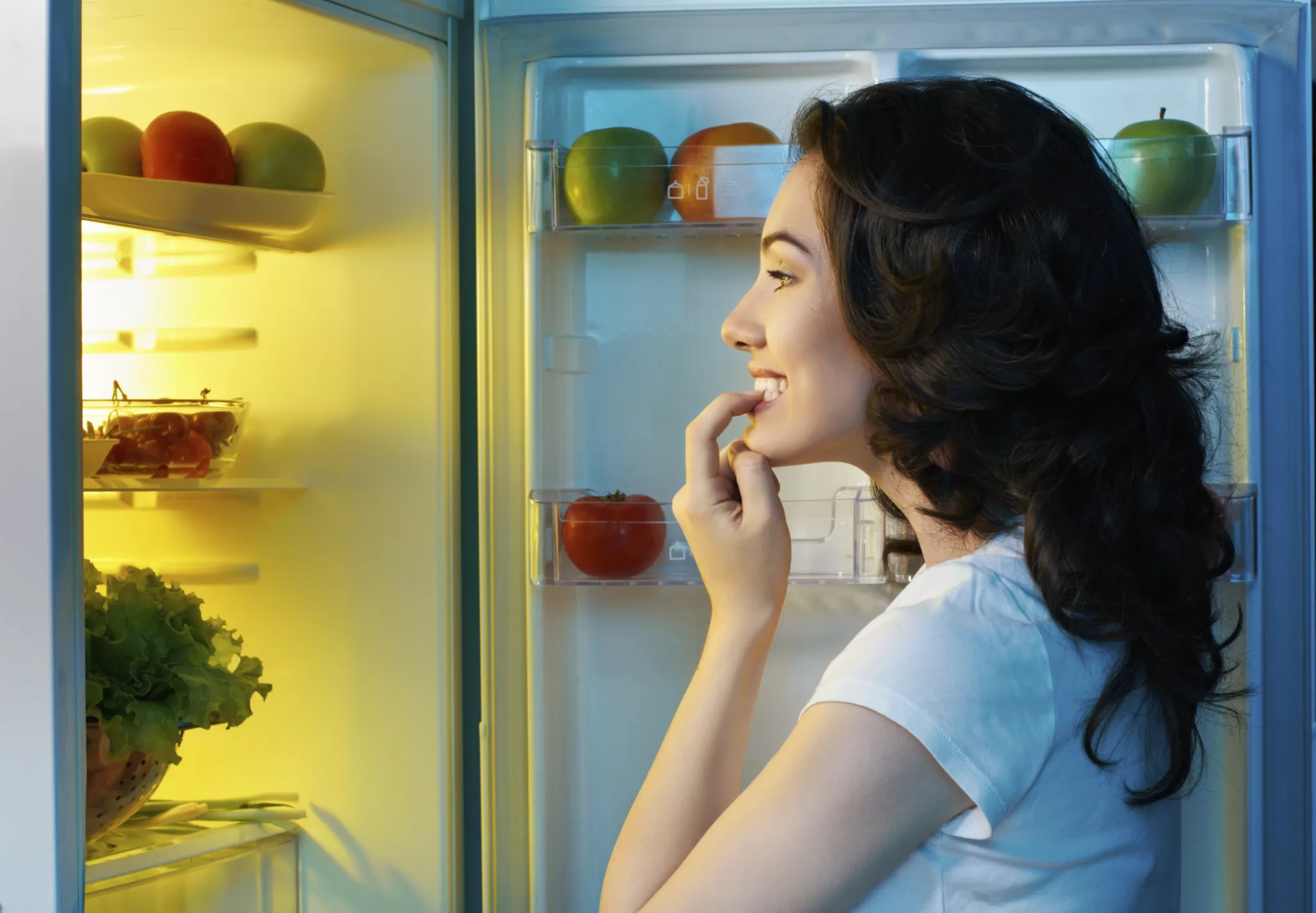 Девушка у холодильника. Заглядывает в холодильник. Человек у холодильника ночью. Холодильник с едой. Кушать после 6 вечера